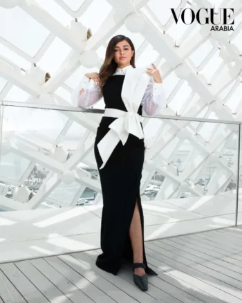 Saudi beauty and fashion influencer Eleensu wearing a long black and white dress for her Vogue Magazine Photoshoot